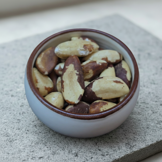 Brazil Nuts in a ceramic bowl on a stone slab