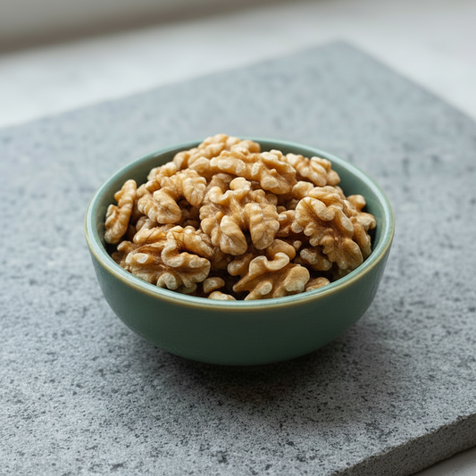 Walnuts in a ceramic bowl on a stone slab