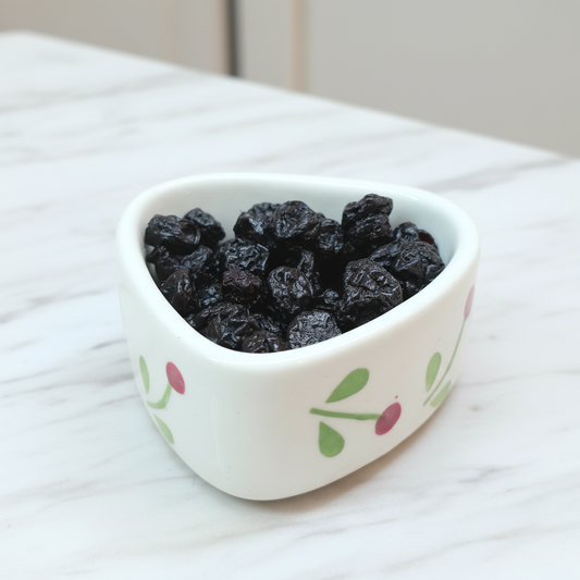 Dried Blueberries in a ceramic bowl on a marble table