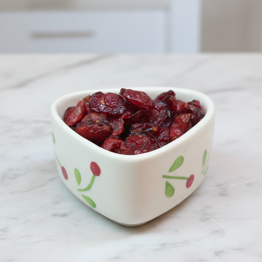 Dried Cranberries in a ceramic bowl on a marble table